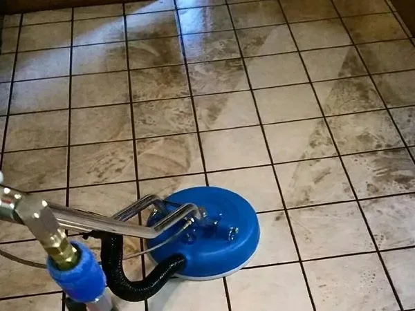 Truck-mounted steam cleaning a tile and grout kitchen floor