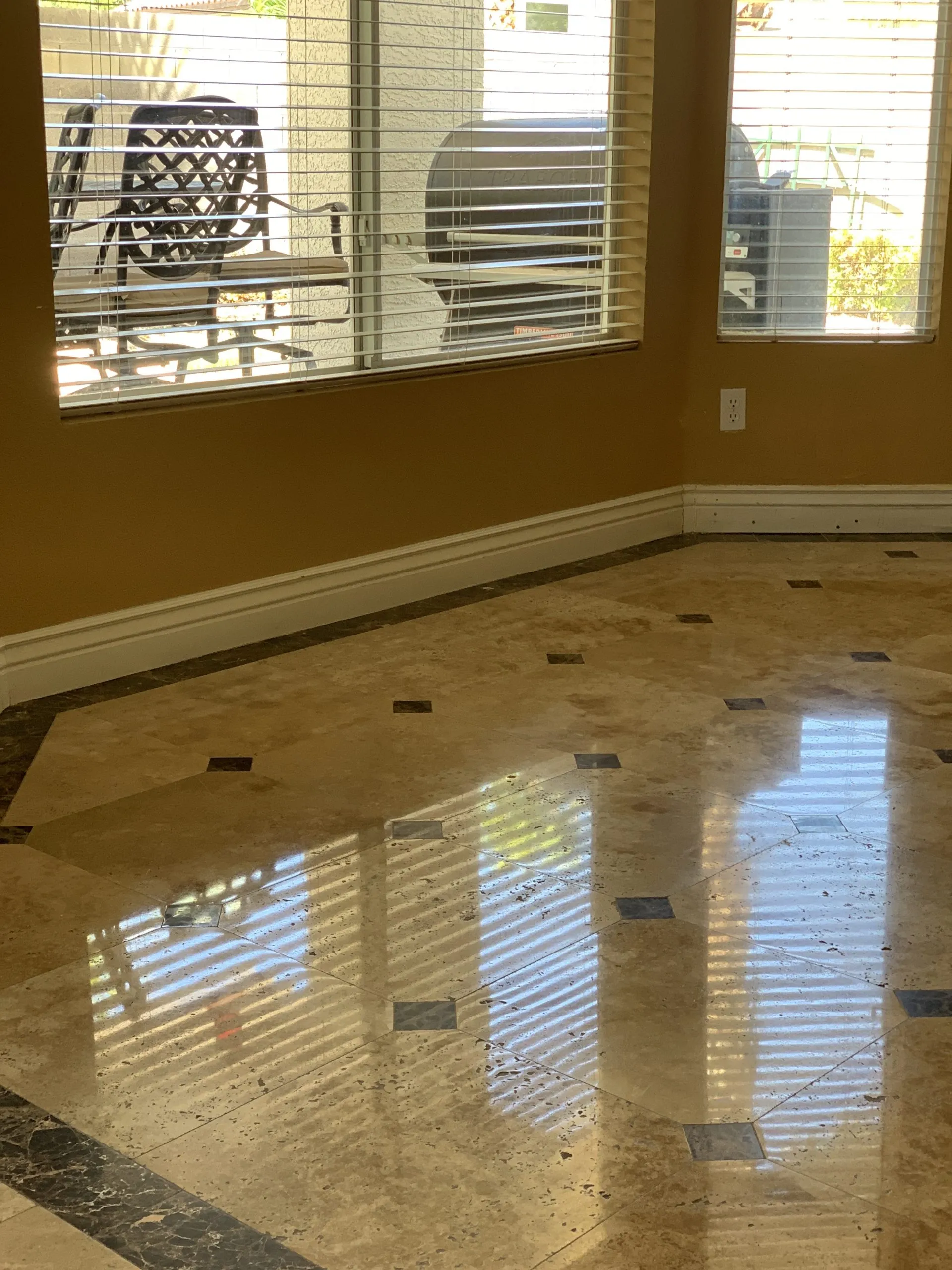 Polished travertine living room floor with mirror reflection in a residential home